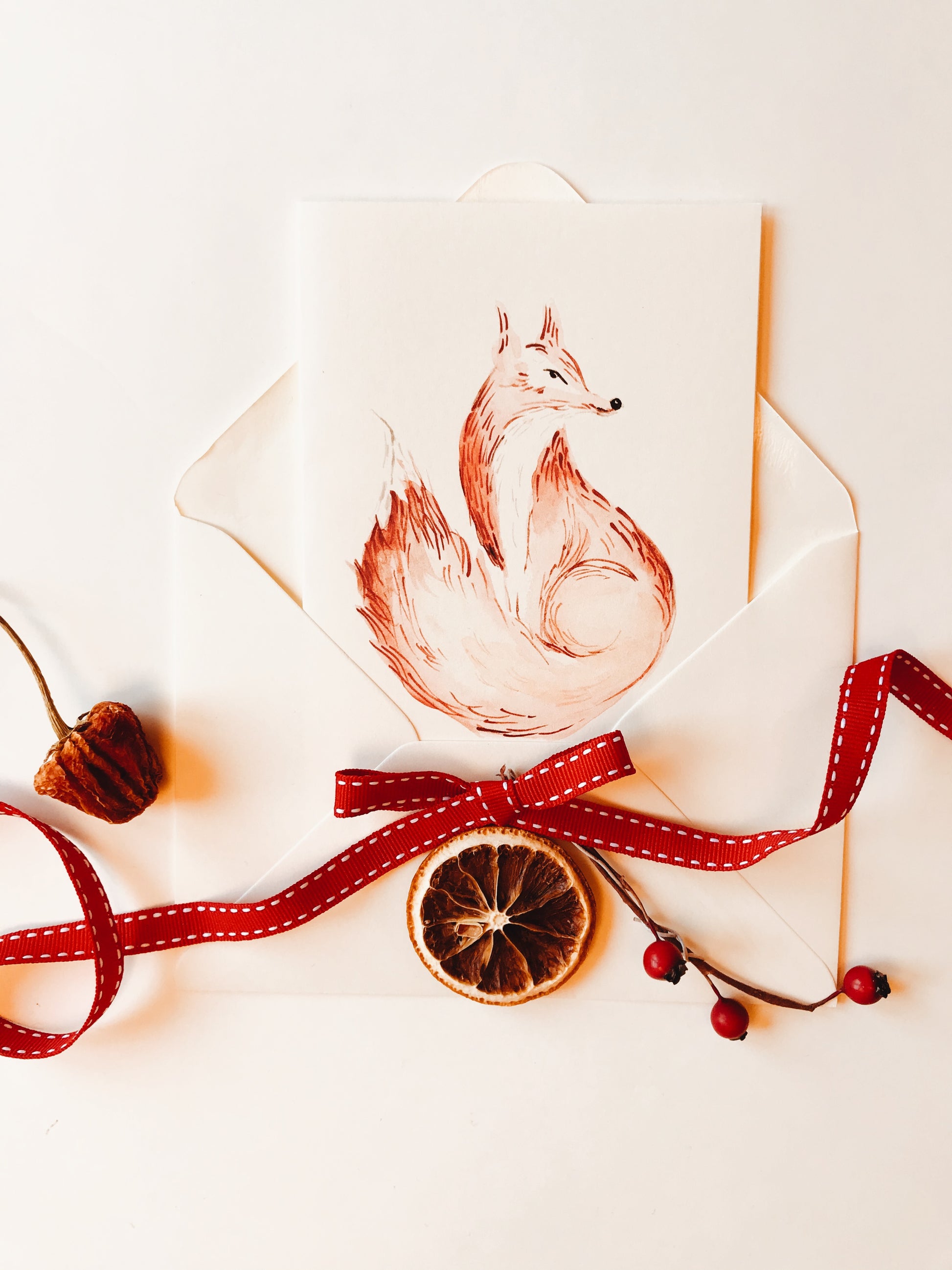 Fox Christmas Greeting Card by Maria Zvaric Illustration. Festive card showcasing a playful fox illustration, ideal for sending warm and cheerful Christmas greetings.